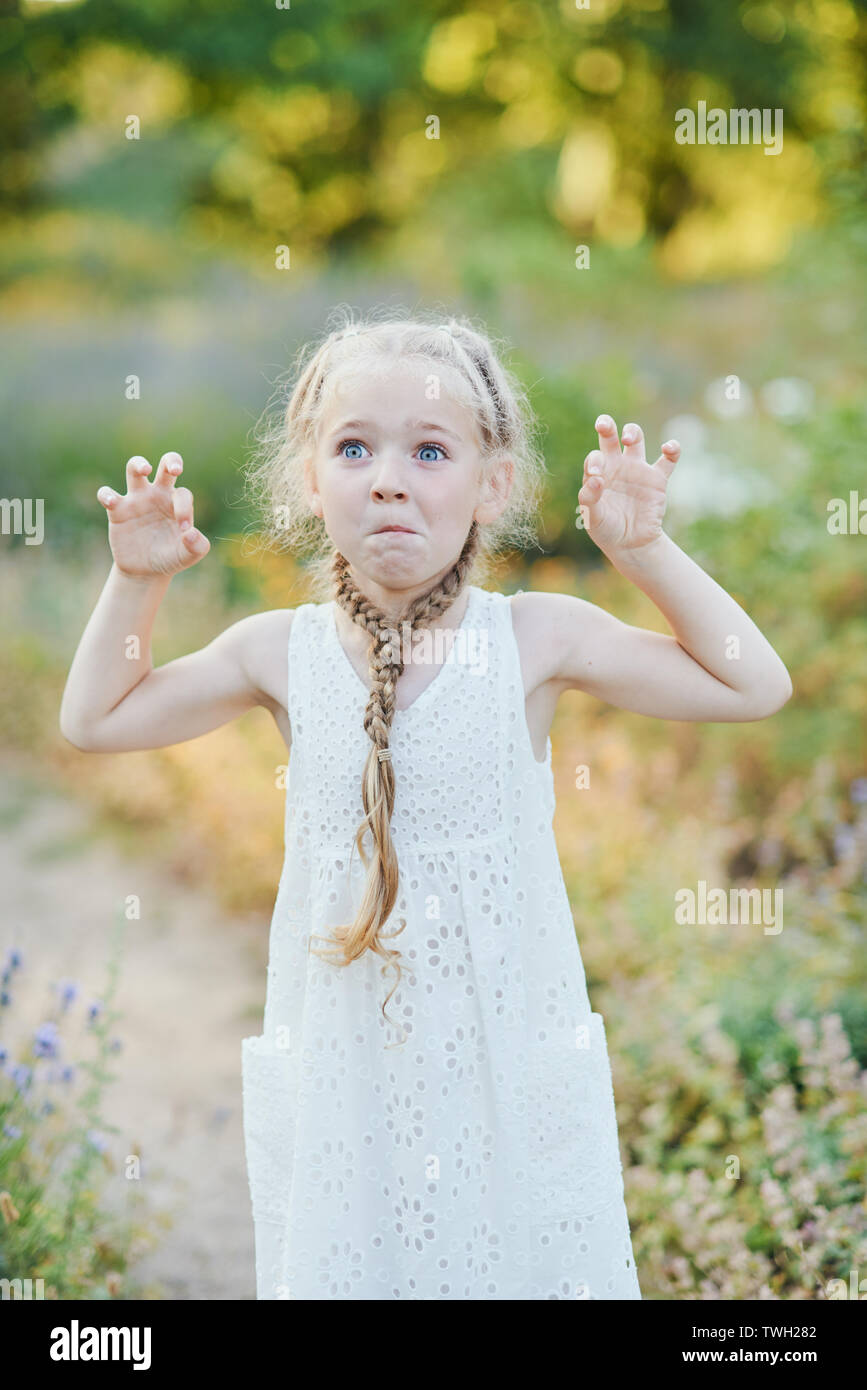 Funny Girl Holding Hair Plaits Small Cute Girl With Long Blonde