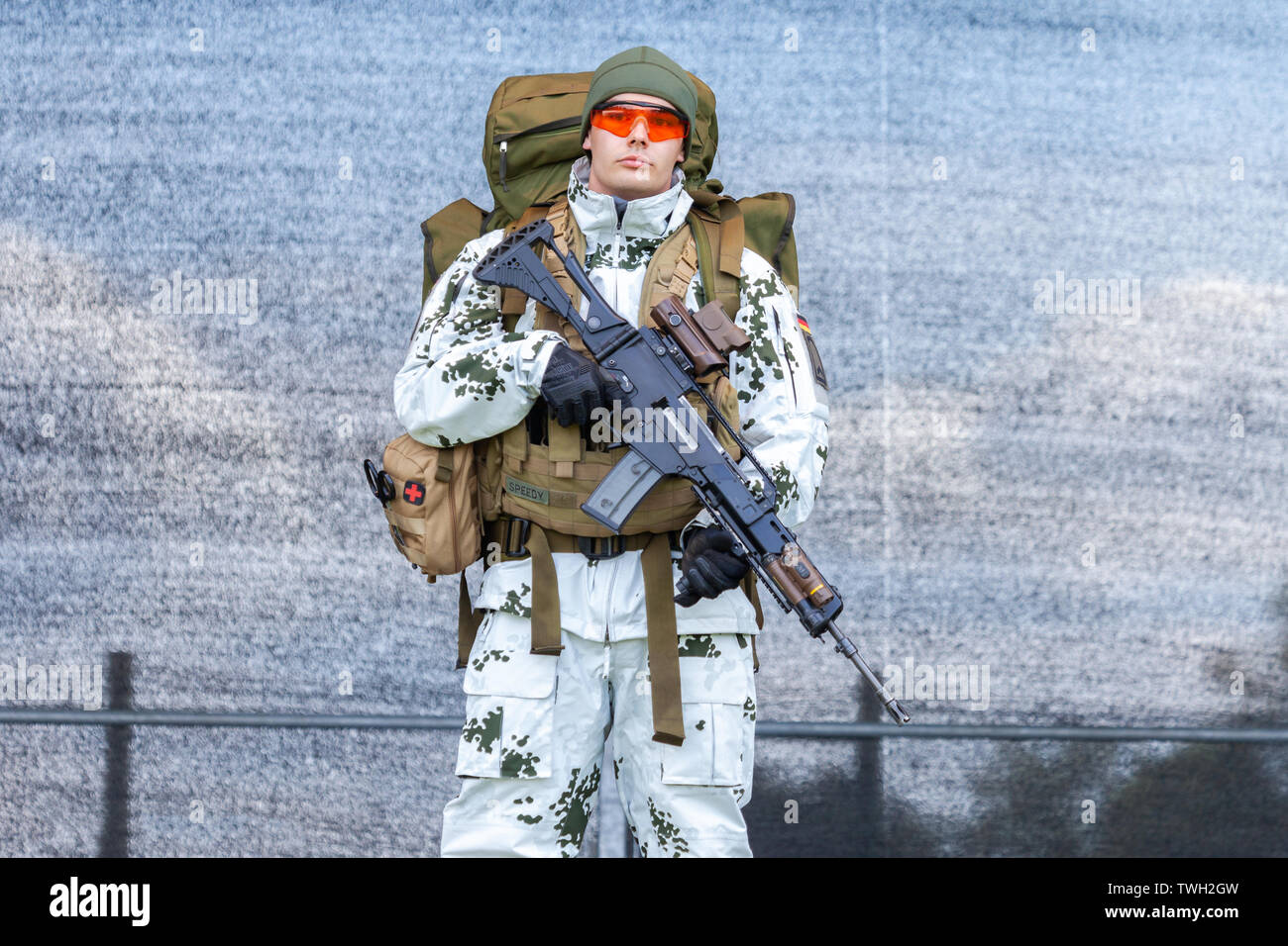 AUGUSTDORF / GERMANY - JUNE 15, 2019: German mountain trooper in snow camouflage suit walks on a stage at Day of the Bundeswehr 2019. Stock Photo