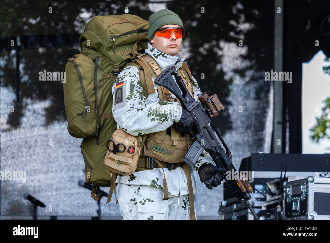 AUGUSTDORF / GERMANY - JUNE 15, 2019: German mountain trooper in snow camouflage suit walks on a stage at Day of the Bundeswehr 2019. Stock Photo