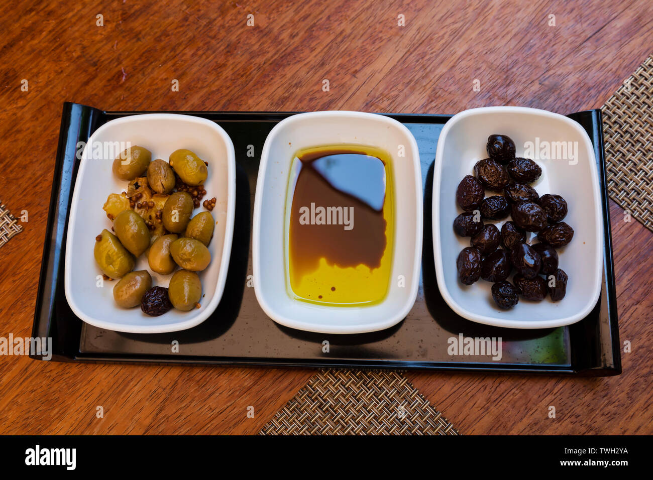 A selection of green and black olives with olive oil and balsamic vinegar.  Turkish Republic of Northern Cyprus. Stock Photo