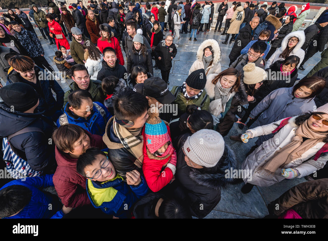 Tourists trying to step on the central point of Circular Mound Altar called Heart of Heaven in Temple of Heaven in Beijing, China Stock Photo