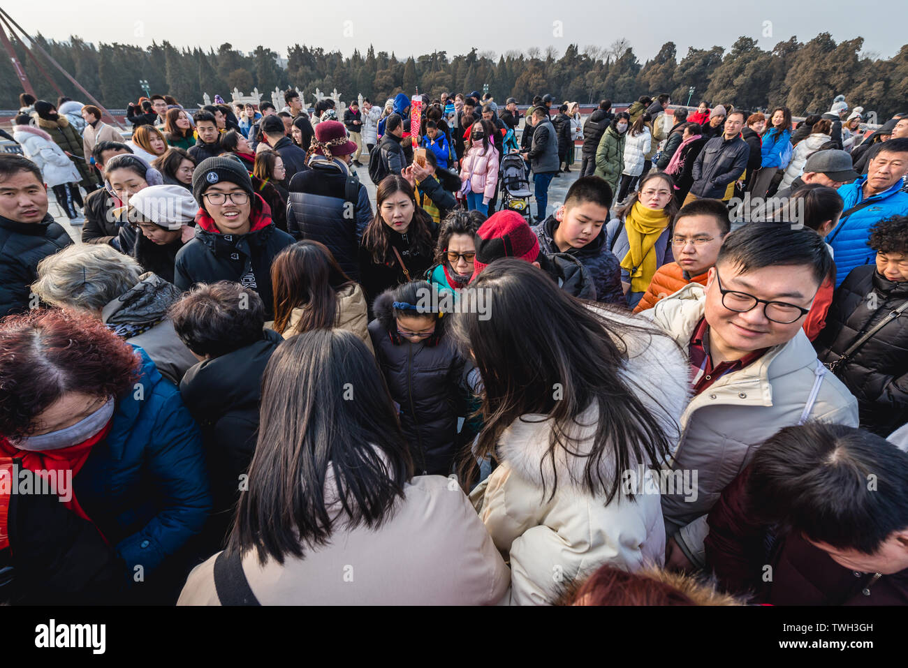 Tourists trying to step on the central point of Circular Mound Altar called Heart of Heaven in Temple of Heaven in Beijing, China Stock Photo