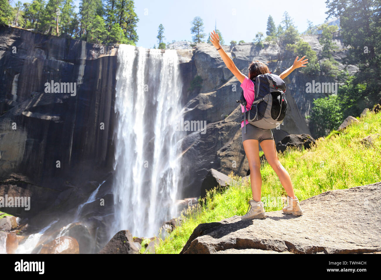 Hiking Woman Freedom In Yosemite National Park By Waterfall Cheering Happy Hiker Enjoying View Of Beautiful Vernal Fall Young Girl On Hike In Beautiful Summer Nature Landscape California Usa Stock Photo