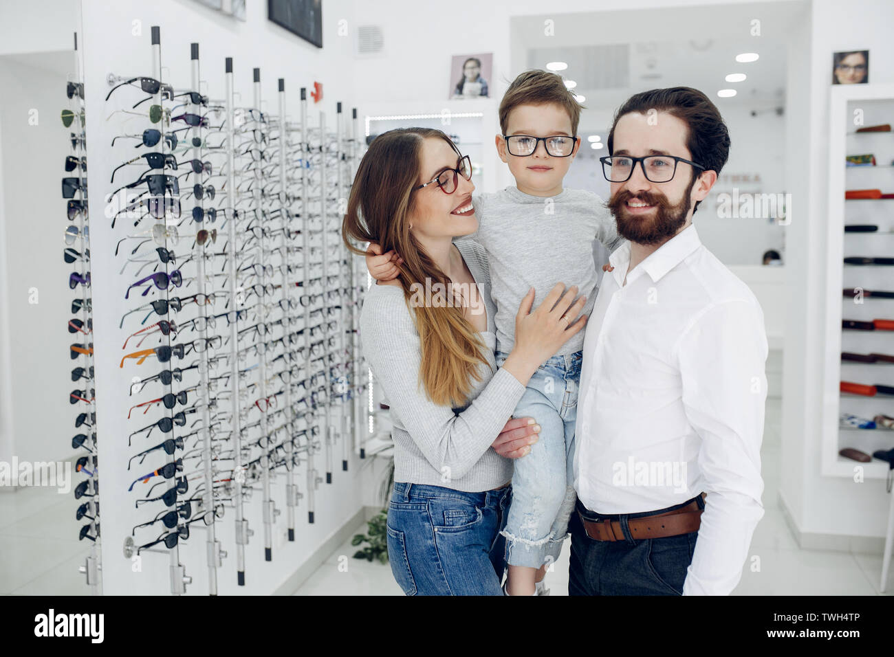 Family with little son in the glasses store Stock Photo