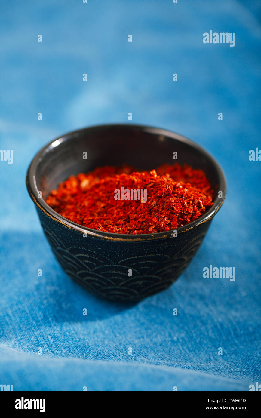 chipotle jalapeno smoked chili flakes in vintage mould tin on textured woden background Stock Photo