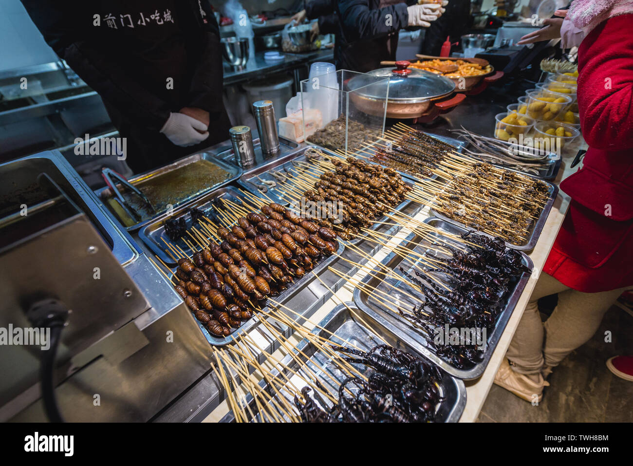 Silkworms and scorpions in indoor food stand on Qianmen Street in Beijing, China Stock Photo
