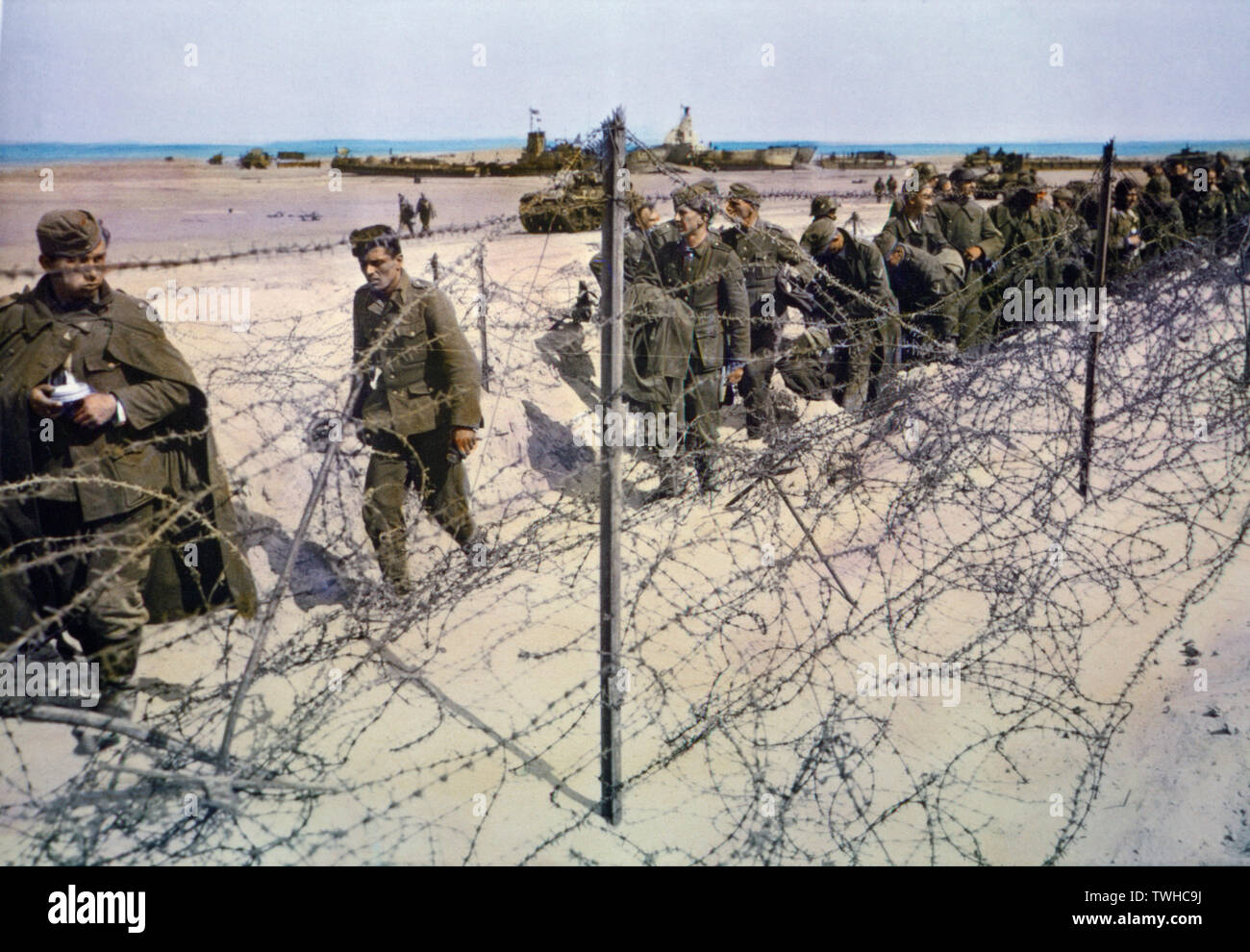 Captured German Soldiers Kept in Barbed Wire Enclosure on Beach during Invasion of Normandy, France, June 1944 Stock Photo