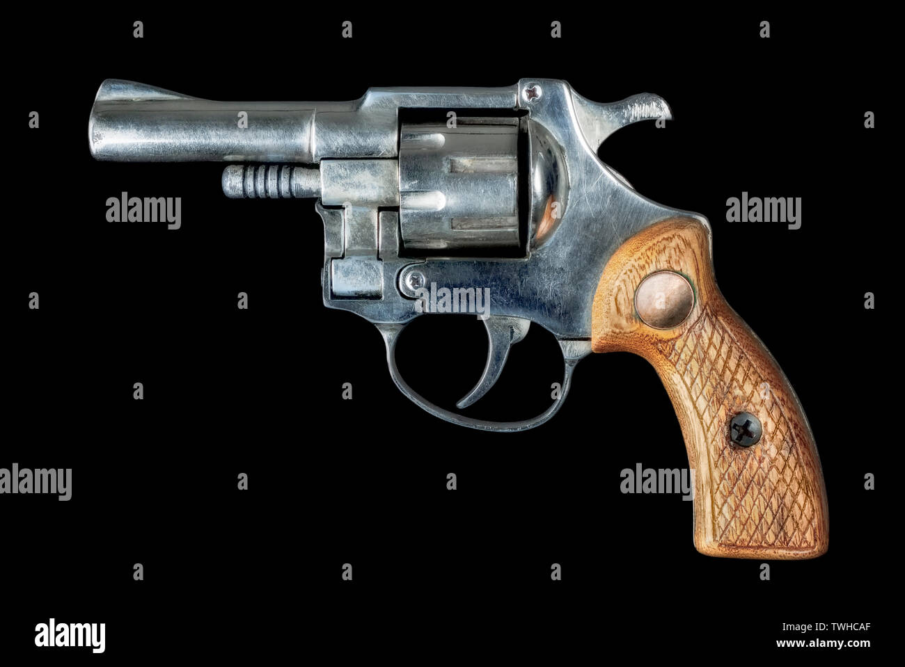 Image of an old revolver with a wood hilt on a black bakground Stock Photo