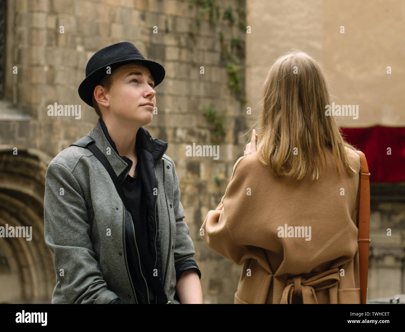 Boy and girl are sitting outdoor and talking.They are speek and enjoing of joint walk Stock