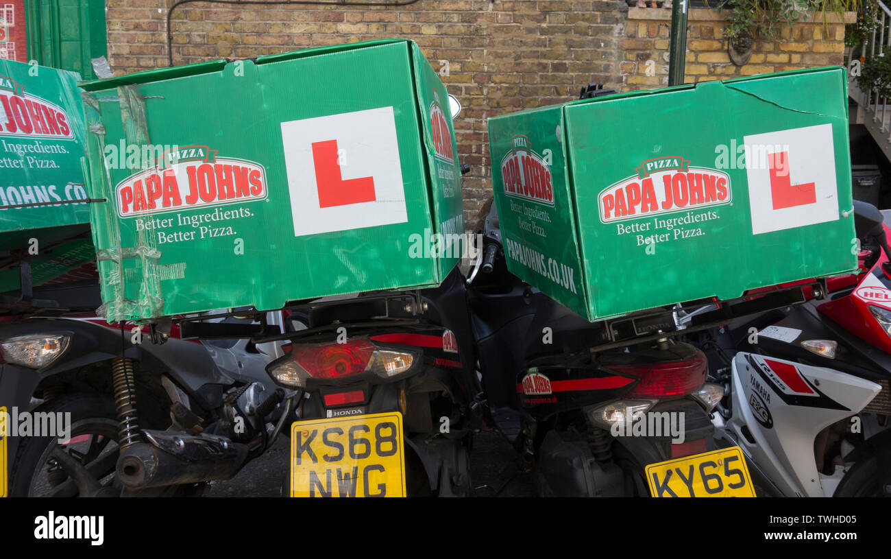 Parked Papa John's Pizza delivery scooters in East Sheen, London, UK Stock  Photo - Alamy