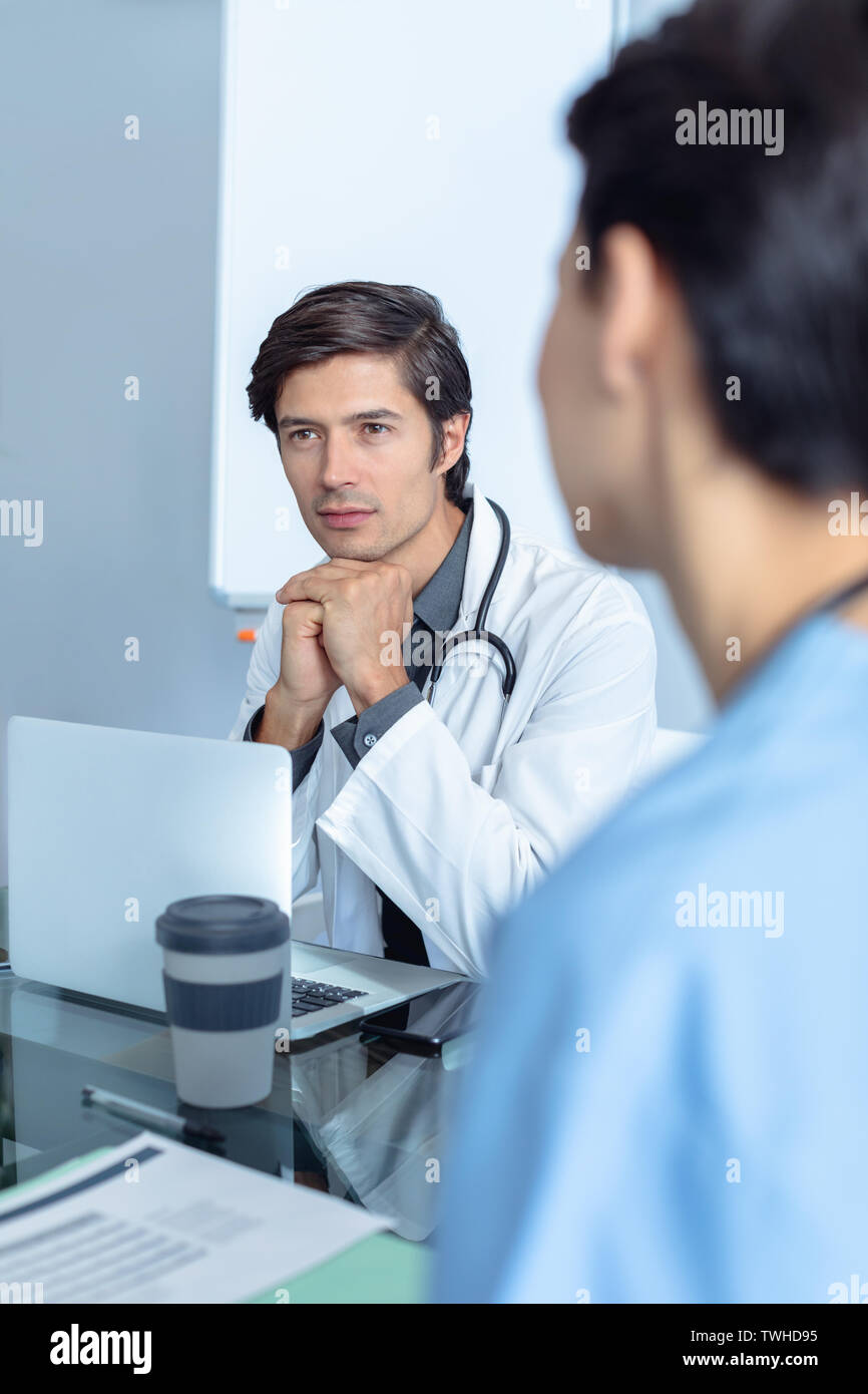 Medical team sitting discussing table hi-res stock photography and ...