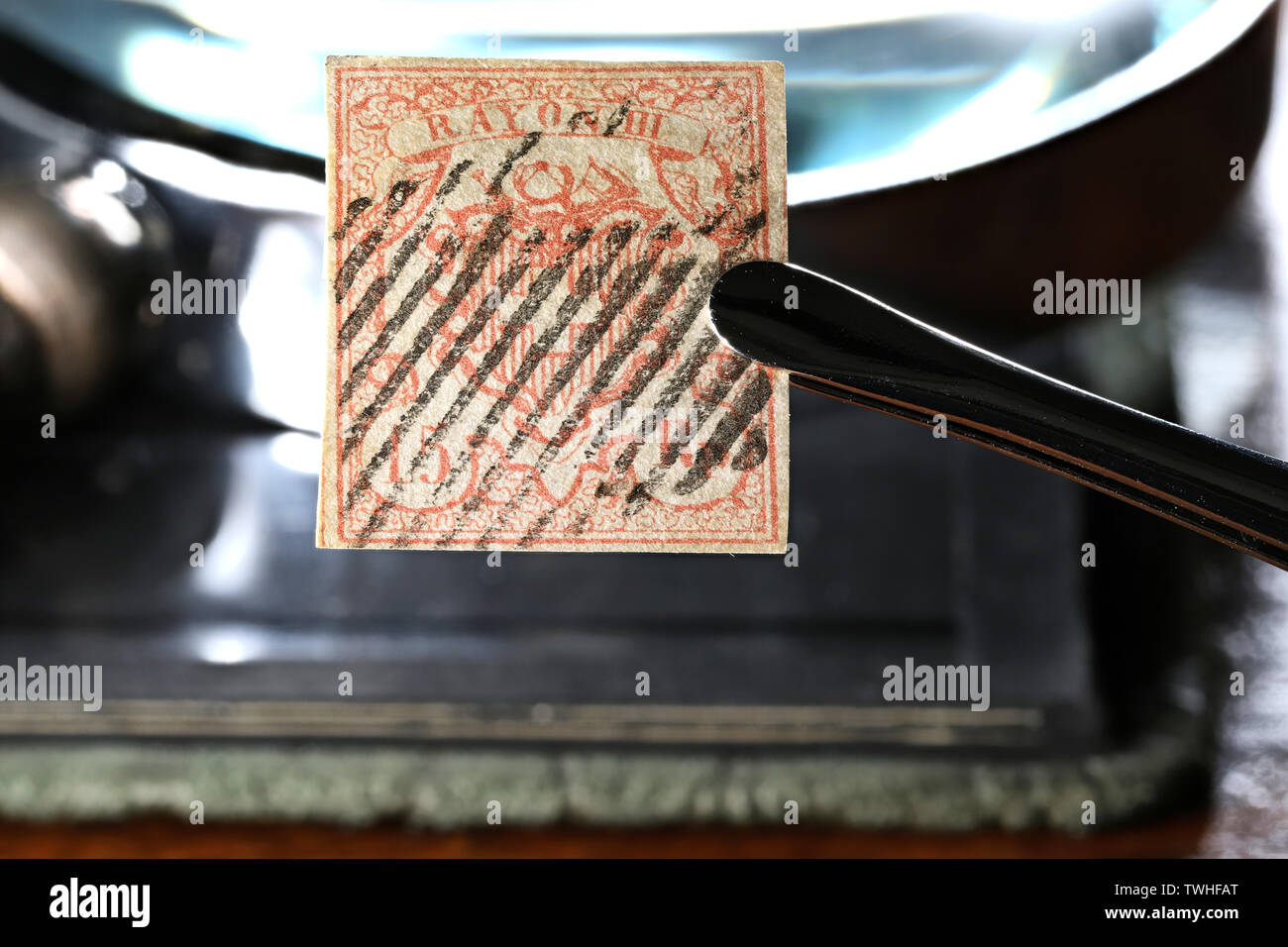 Swiss 15 Rappen Rayon III stamp held by tweezers. Stock Photo