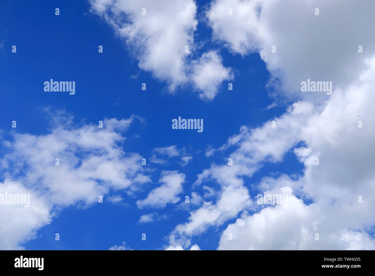 Large white clouds covering a blue sky Stock Photo