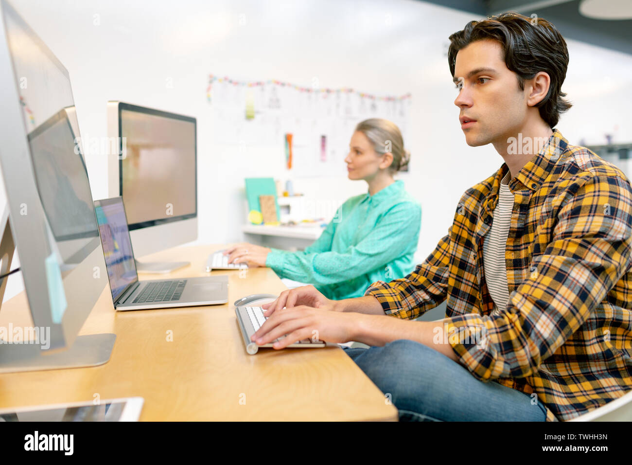 Male and female executive working on computer Stock Photo
