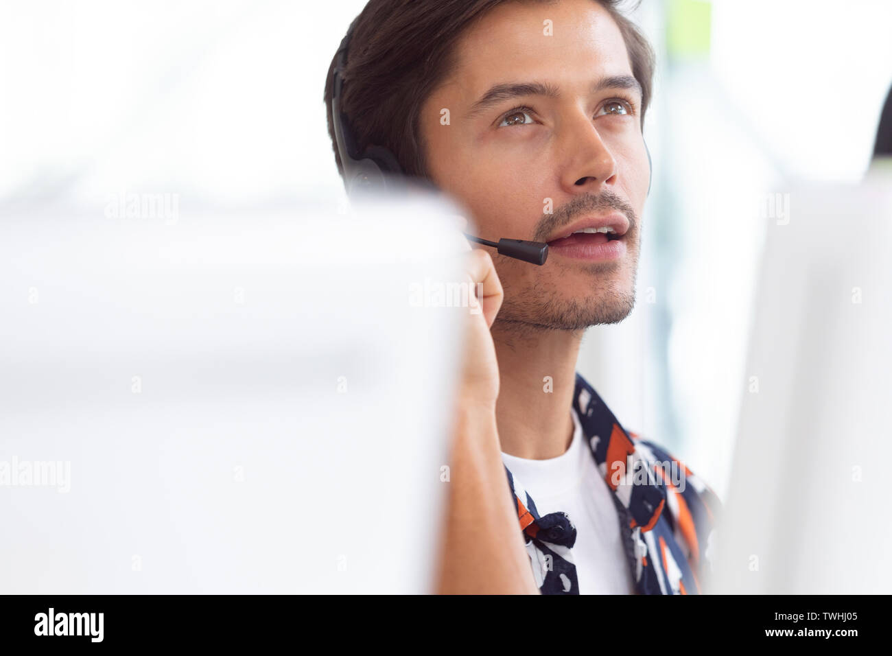 Male customer service executive working on computer at desk Stock Photo