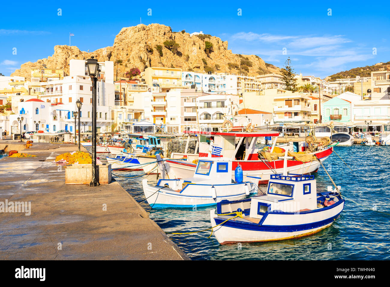 Fishing boats in picturesque Pigadia port at sunset time, Karpathos island, Greece Stock Photo