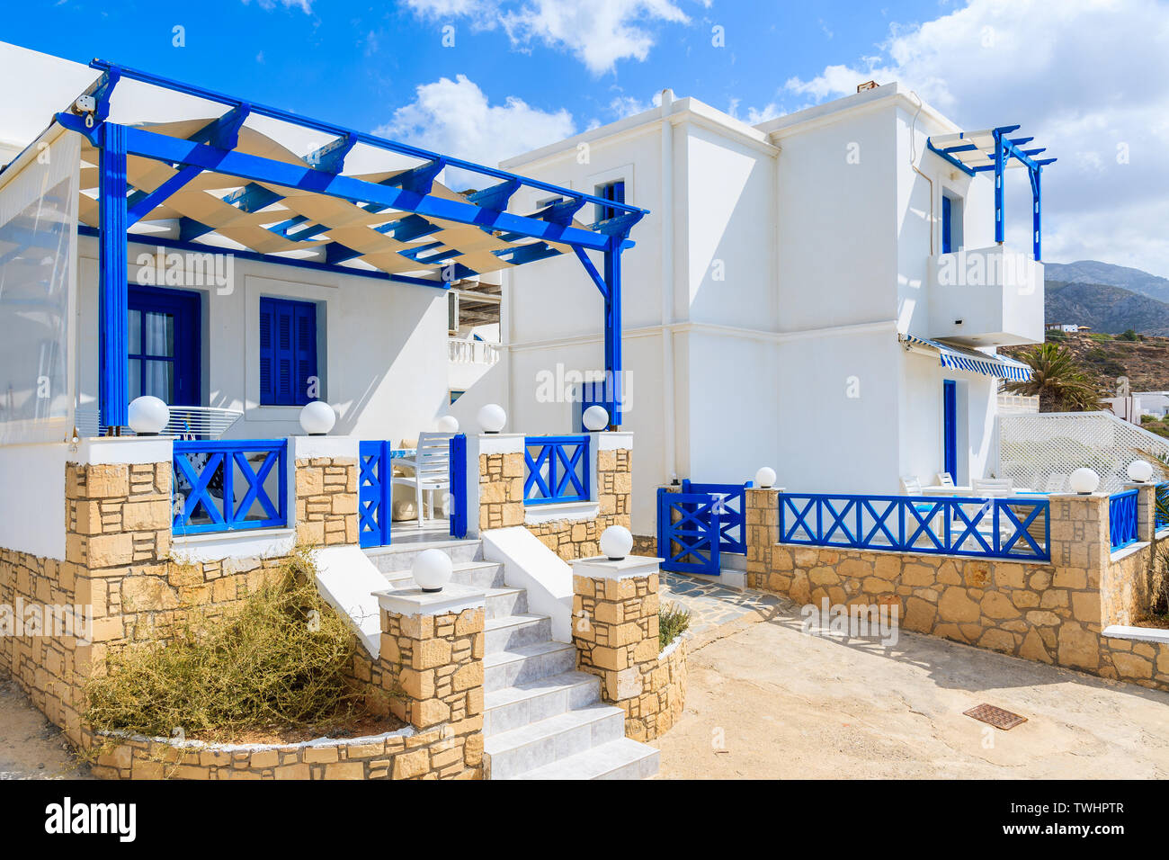 Typical Greek white and blue color tourist apartments in Lefkos village
