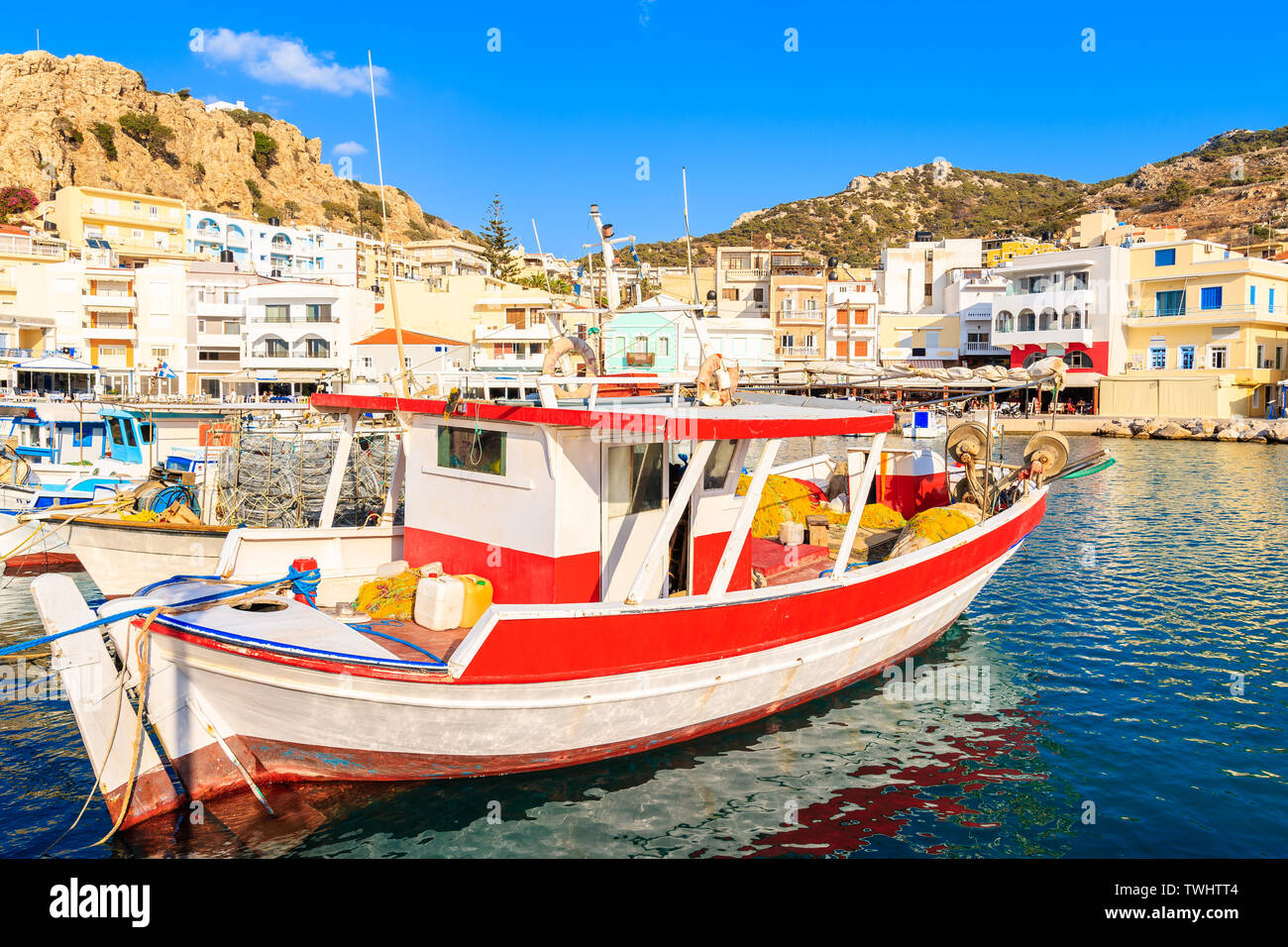 Fishing boats in Pigadia port on Karpathos island at sunset time, Greece Stock Photo