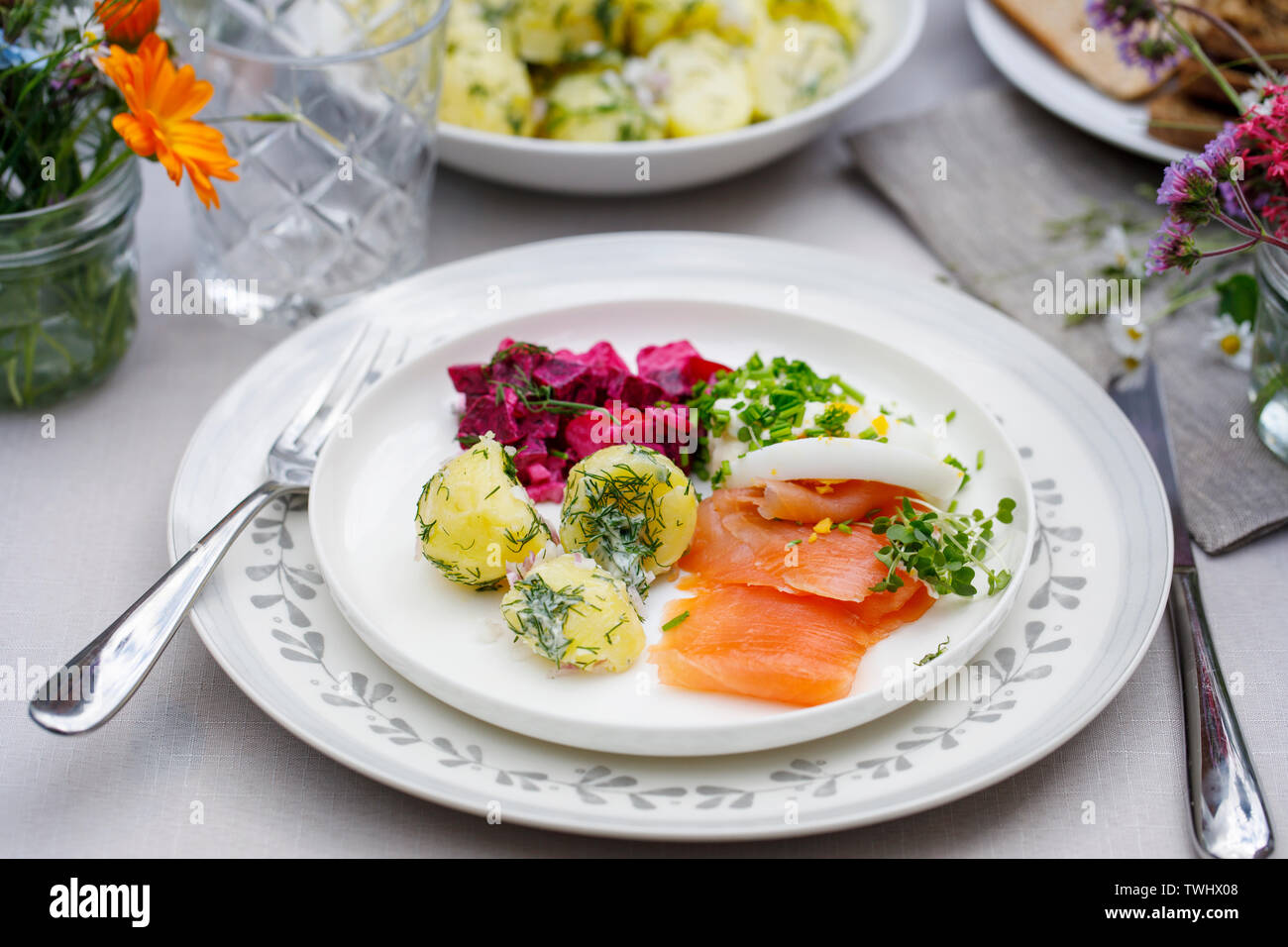 Scandinavian midsummer feast with potato salad,  salmon and beetroot Stock Photo