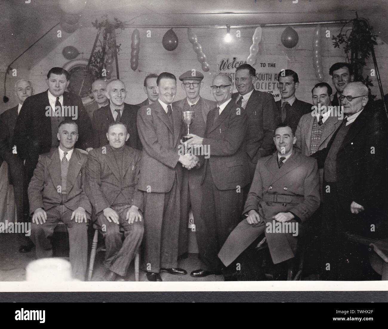 Vintage black and white photo of group of men, awarding being presented Stock Photo