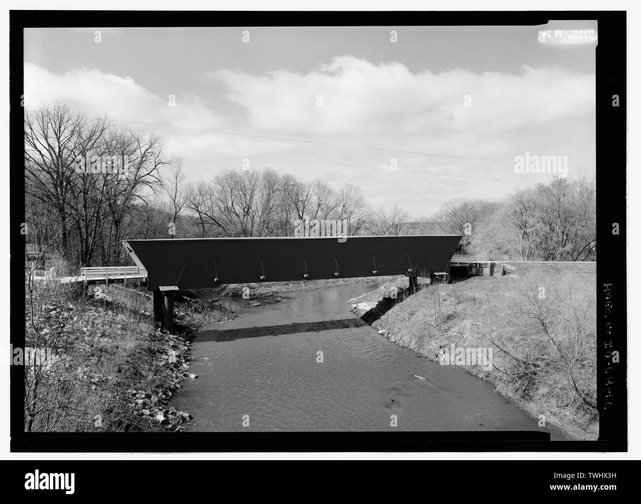 SIDE ELEVATION. NOTE NEARLY FLAT ROOF AND IRON TUBULAR PIERS