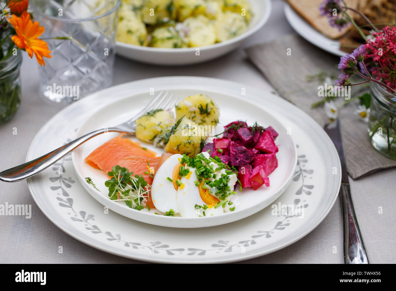 Scandinavian midsummer feast with potato salad, salmon and beetroot Stock Photo