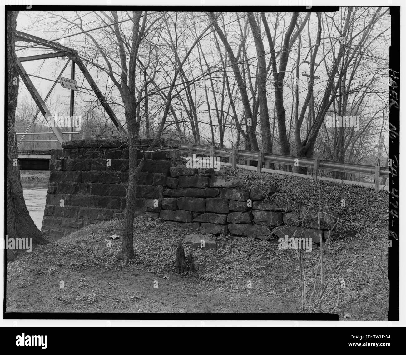 SIDE VIEW OF NORTHEASTERN ROCKFACED DRESSED AND MORTARED STONE BRIDGE ABUTMENT (LEFT) AND DRESSED, DRY-LAID RETAINING WALL (RIGHT). FACING WEST. - Coverts Crossing Bridge, Spanning Mahoning River along Township Route 372 (Covert Road), New Castle, Lawrence County, PA; Lawrence County Commissioners; Morse Bridge Company; Covert, John W; Kirk, H M; Craig, Jos; Chambers, St S; Wagoner, A G; Morse, Henry G; Morse, C J; Lawrence County Bridge Department, sponsor; GAI Consultants, Incorporated, contractor; Christianson, Justine, transmitter; Croteau, Todd, project manager; Flores, Roland, field team Stock Photo