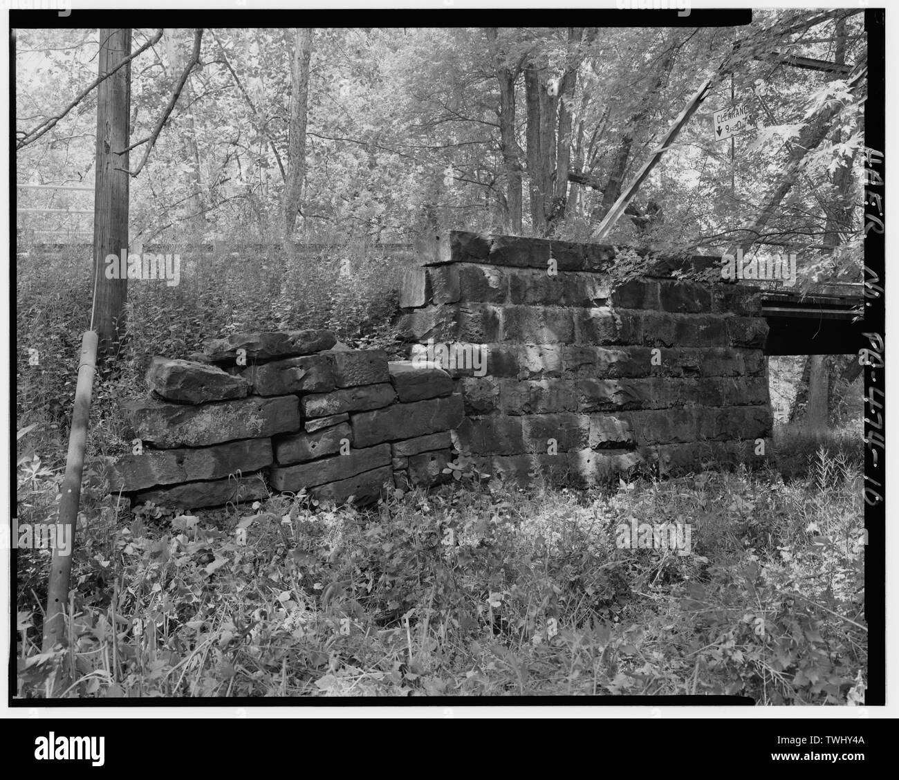 SIDE VIEW OF SOUTHEASTERN ROCKFACED DRESSED AND MORTARED STONE BRIDGE ABUTMENT (RIGHT) AND DRESSED, DRY-LAID RETAINING WALL (LEFT). FACING NORTHWEST. - Coverts Crossing Bridge, Spanning Mahoning River along Township Route 372 (Covert Road), New Castle, Lawrence County, PA; Lawrence County Commissioners; Morse Bridge Company; Covert, John W; Kirk, H M; Craig, Jos; Chambers, St S; Wagoner, A G; Morse, Henry G; Morse, C J; Lawrence County Bridge Department, sponsor; GAI Consultants, Incorporated, contractor; Christianson, Justine, transmitter; Croteau, Todd, project manager; Flores, Roland, field Stock Photo