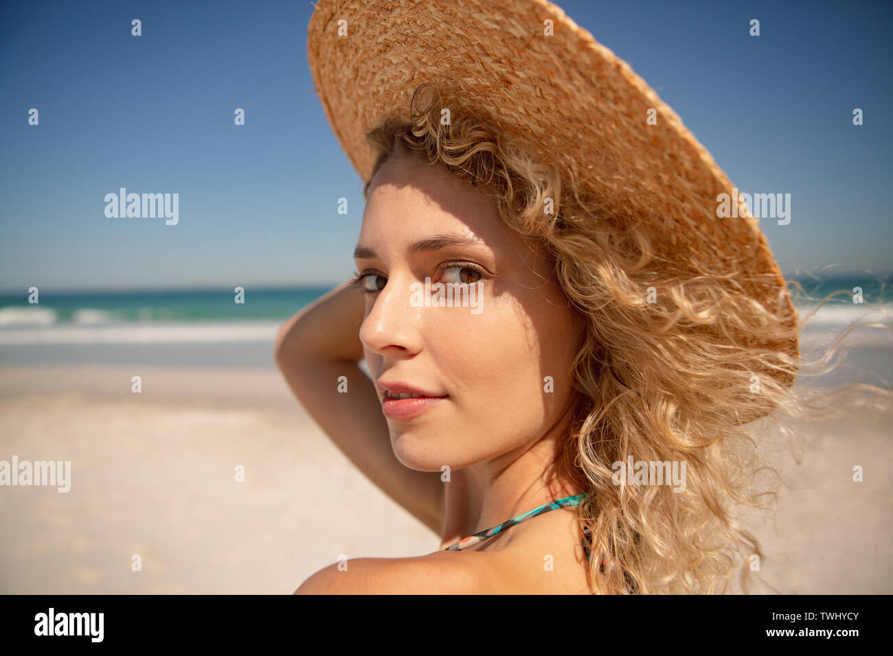 Beautiful woman standing on the beach Stock Photo