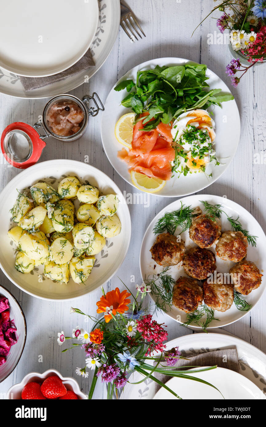 Scandinavian midsummer feast with potato salad, meatballs, salmon and beetroot Stock Photo