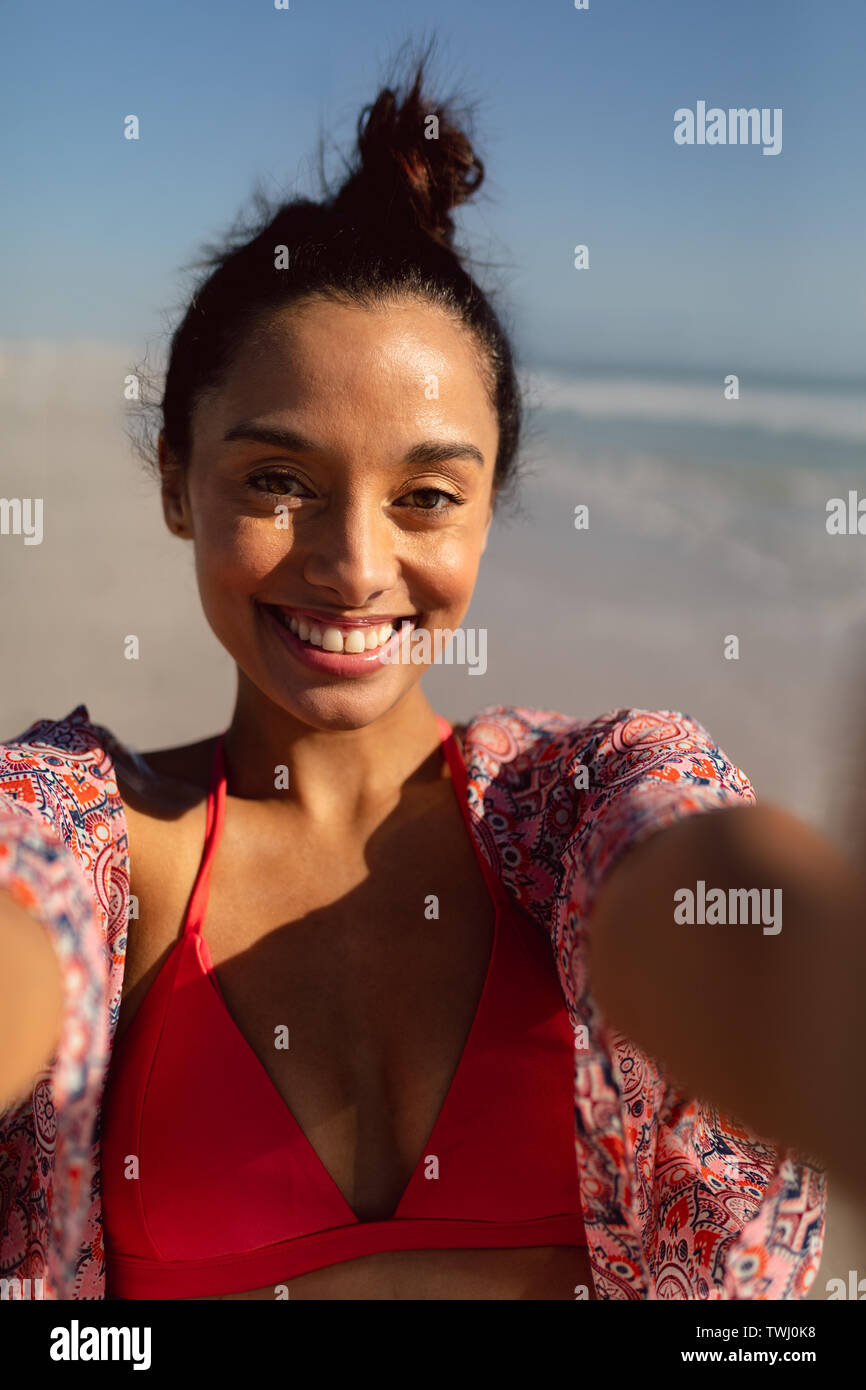 Young woman in bikini standing on the beach Stock Photo