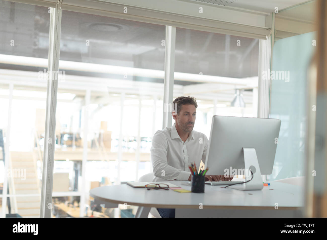 Business executive working on computer at desk in a modern office Stock ...