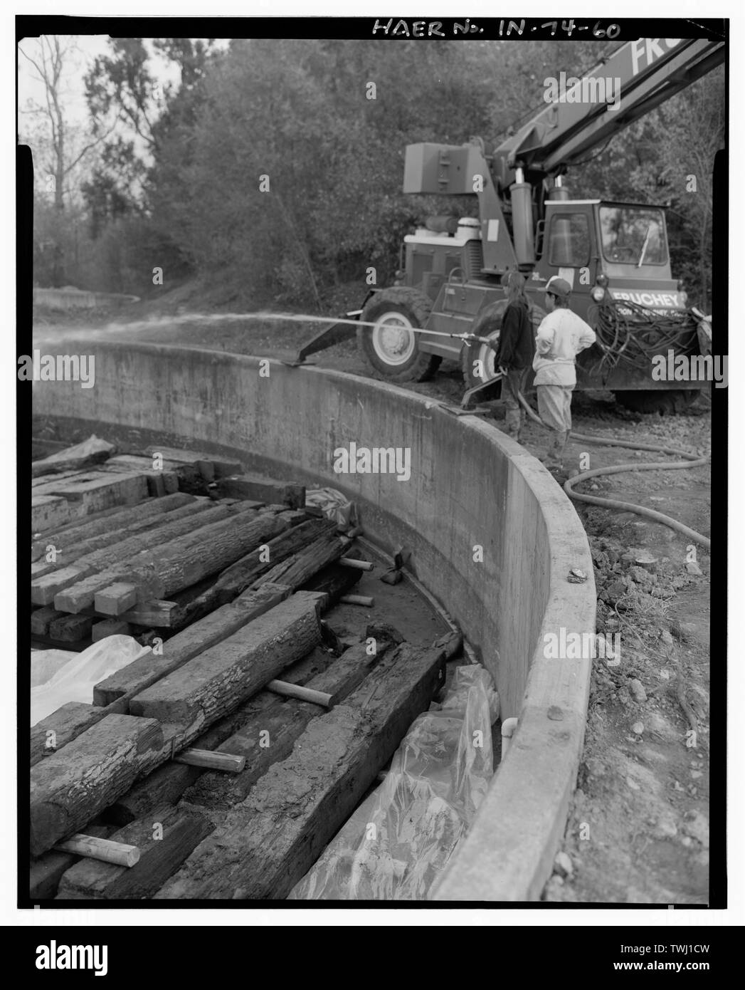 Same view, showing technicians hosing down the timbers. Shortly after this photograph was made, the timbers were completely submerged in water, held down by heavy concrete castings. - Wabash and Erie Canal, Lock No. 2, 8 miles east of Fort Wayne, adjacent to U.S. Route 24, New Haven, Allen County, IN Stock Photo