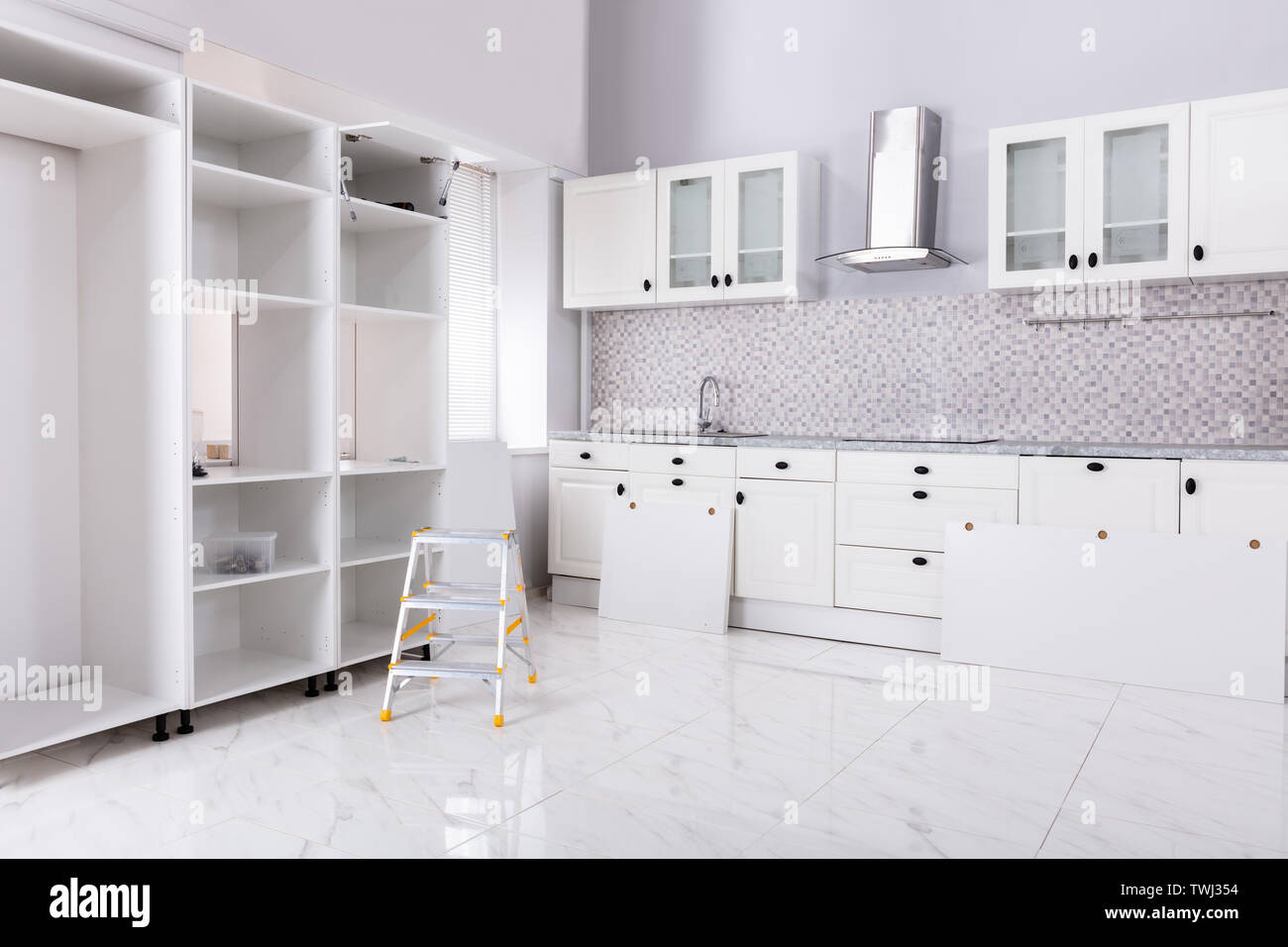 Installation Of Wooden In The White Clean Modular Kitchen