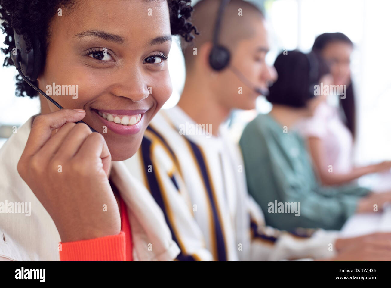 Customer service executives working on computer at desk Stock Photo - Alamy