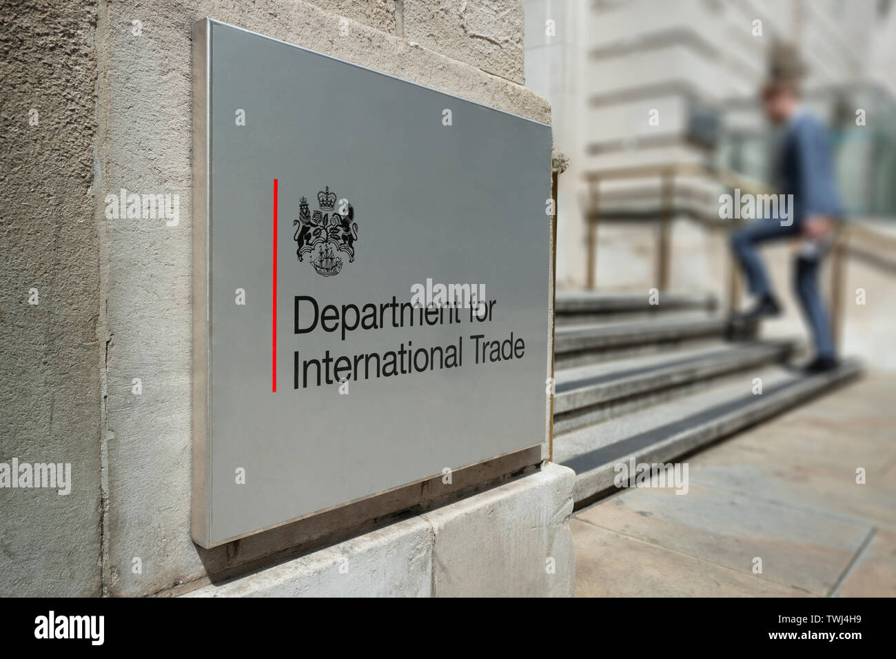 A man enters the Department for International Trade building on Whitehall in London, UK. Stock Photo
