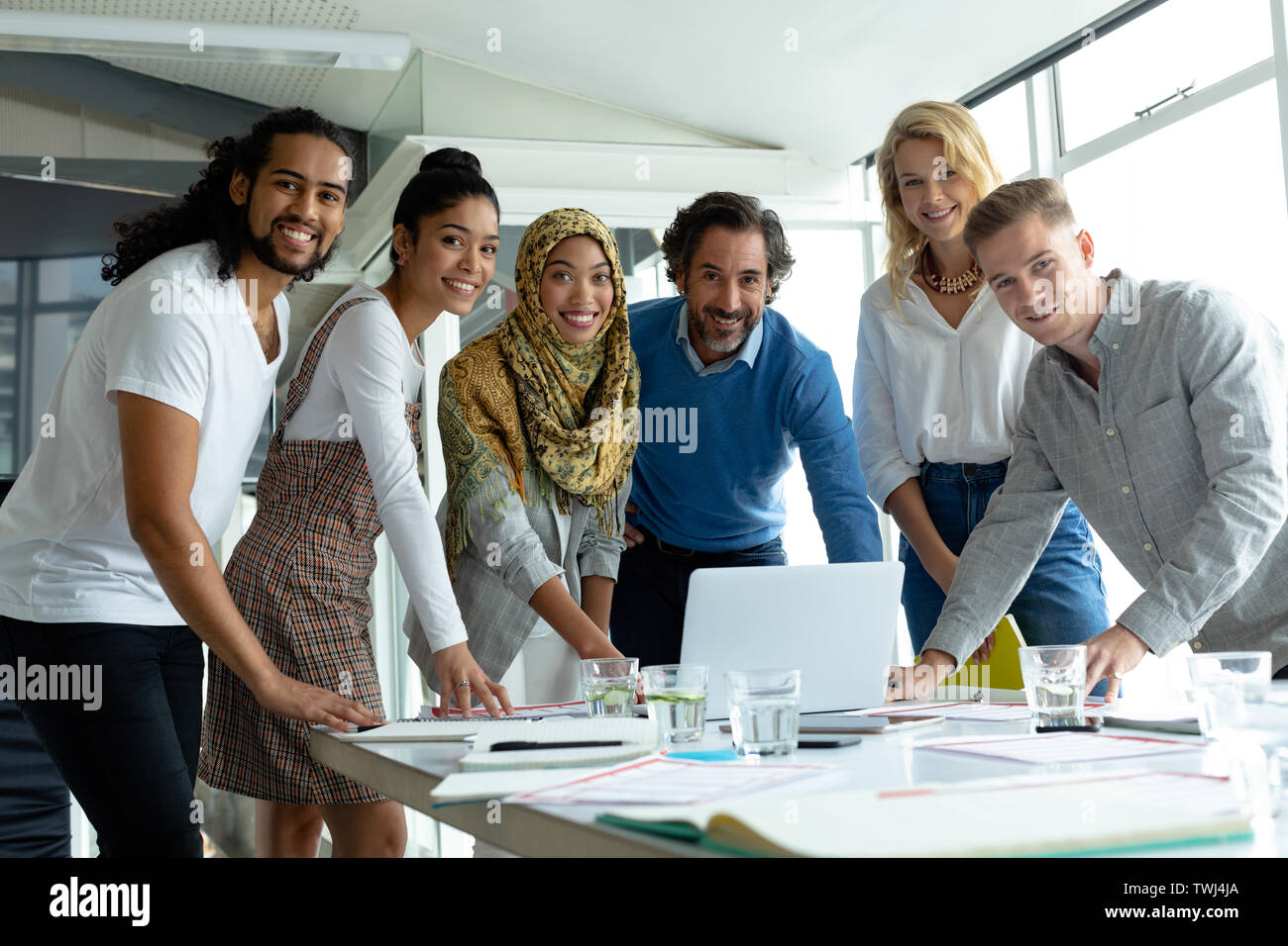 Business People Looking At Camera While Working Together At