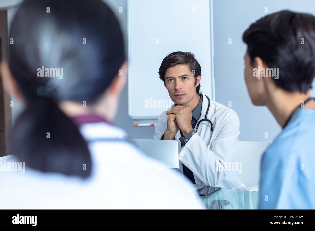 Medical team sitting discussing table hi-res stock photography and ...
