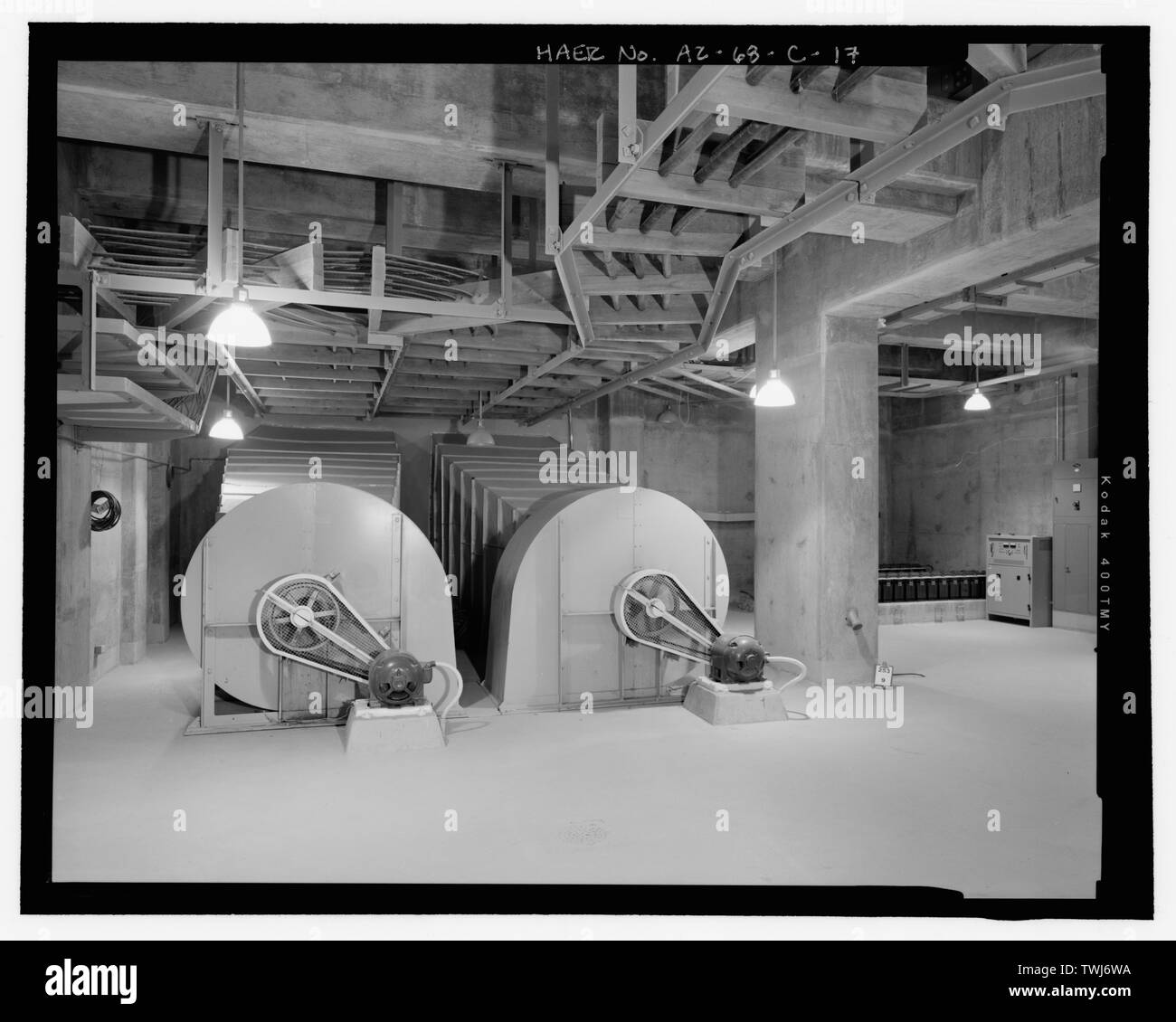 Service bay area, pump room level, showing ventilation fans and ducts association with evaporative-cooling system. Note battery bank at far right. View to the east - Wellton-Mohawk Irrigation System, Pumping Plant No. 3, South of Interstate 8, Wellton, Yuma County, AZ Stock Photo