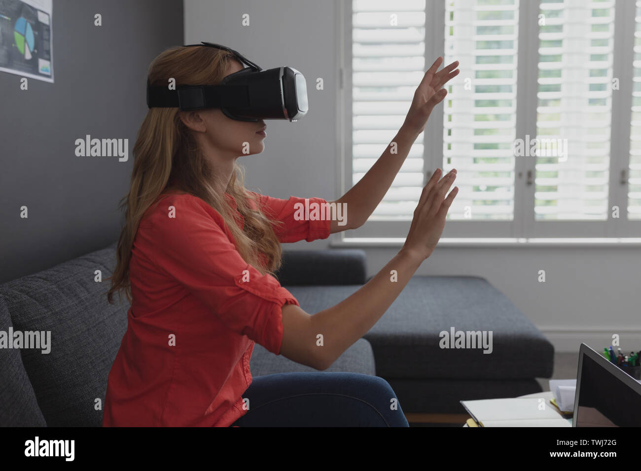 Female executive using virtual reality headset Stock Photo