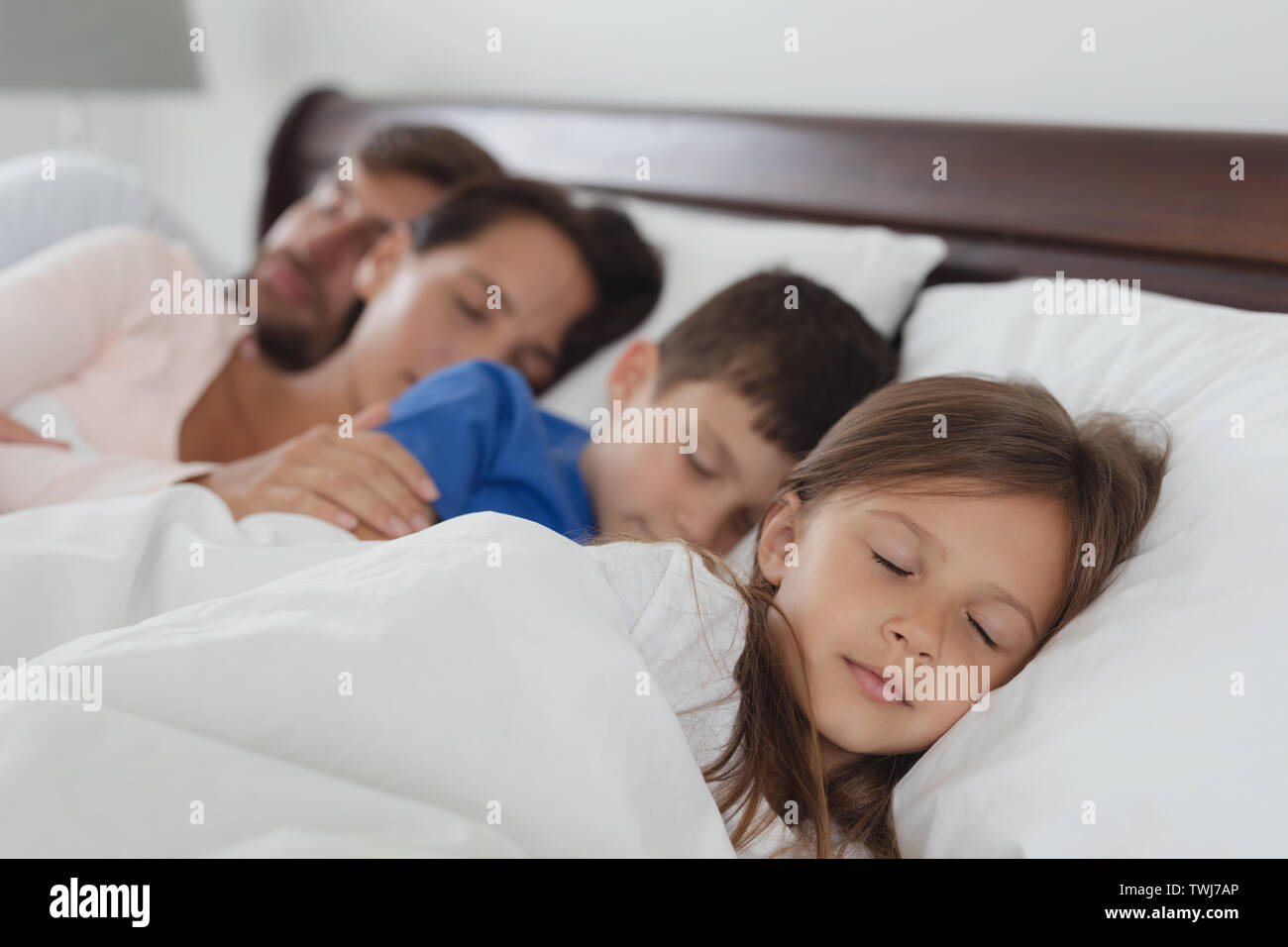 Family Sleeping Together In Bed In Bedroom Stock Photo Alamy   Family Sleeping Together In Bed In Bedroom TWJ7AP 