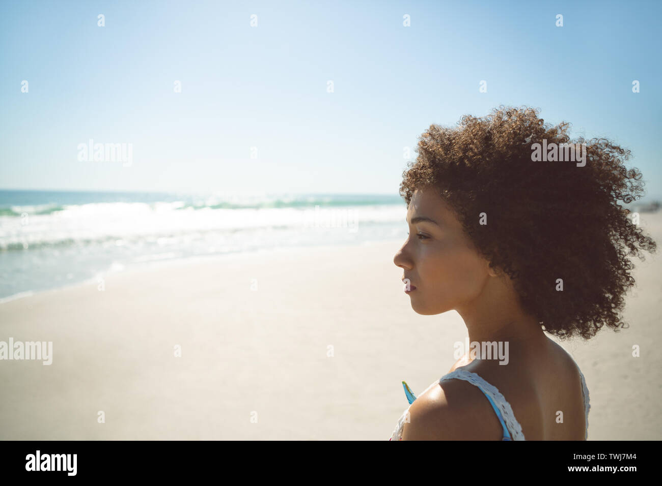 Woman standing on the beach Stock Photo