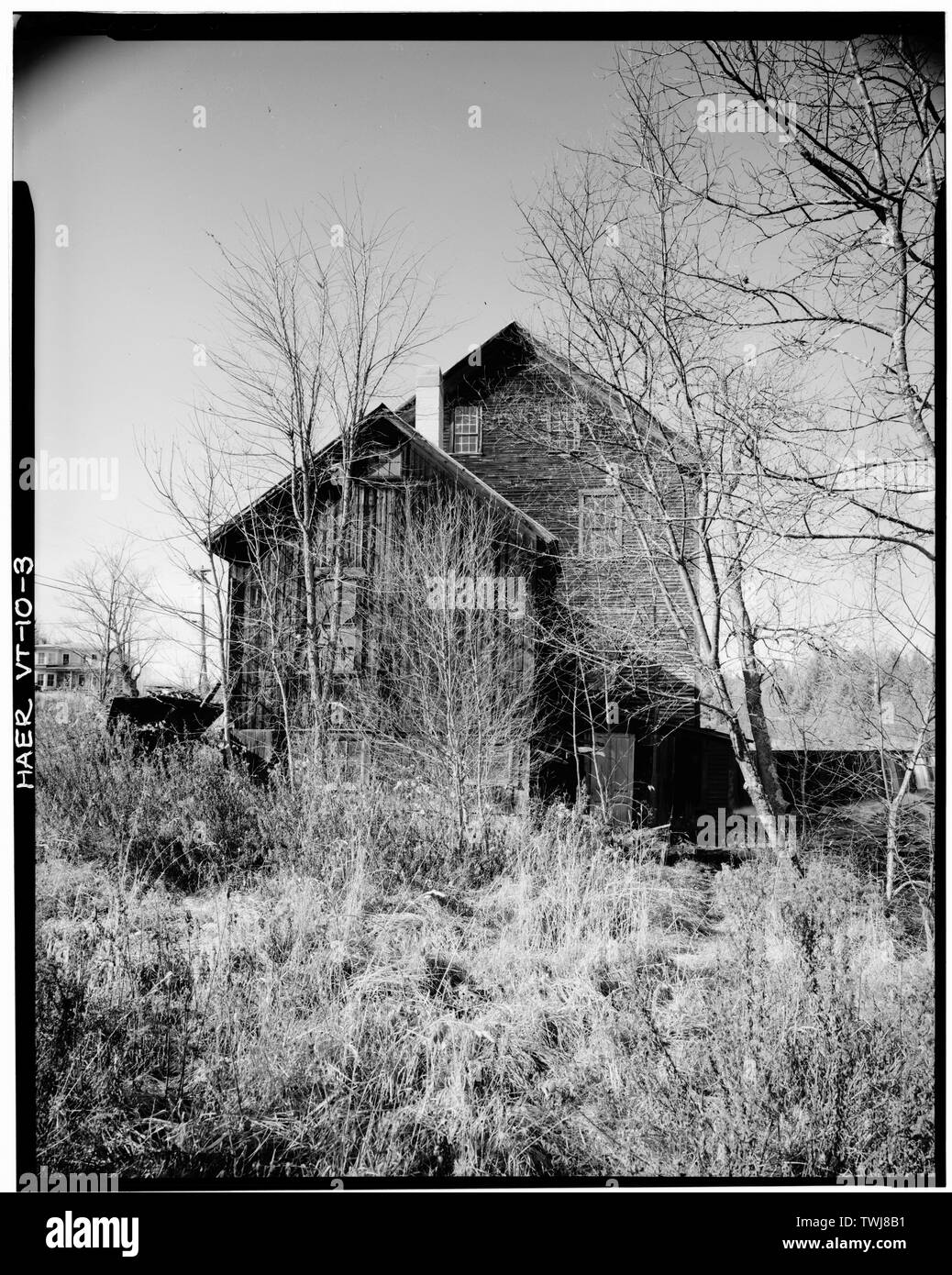 Side (southeast) elevation of Blacksmith Shop and Woodworking Mill. Timber frame and plank dam in right background; Ben Thresher's house in left background. - Ben Thresher's Mill, State Aid No. 1, Barnet, Caledonia County, VT; Rockefeller, Laurance S; Jack, Alexander; Judkins, James Loren; Stevens, Willard; Stevens, Henry; Gleason, Samuel; Barnet Cotton and Woolen Manufacturing Company; Herrin, John; Greenbank, Thomas; Greenbank, George; Taylor, James; Goodwillie, James; Shaw, William; McLaren, James; Somers, James S; Alexander Jack's Dye and Print Works; Smith, Isaac M; Bishop, Ora; Ford, Elm Stock Photo