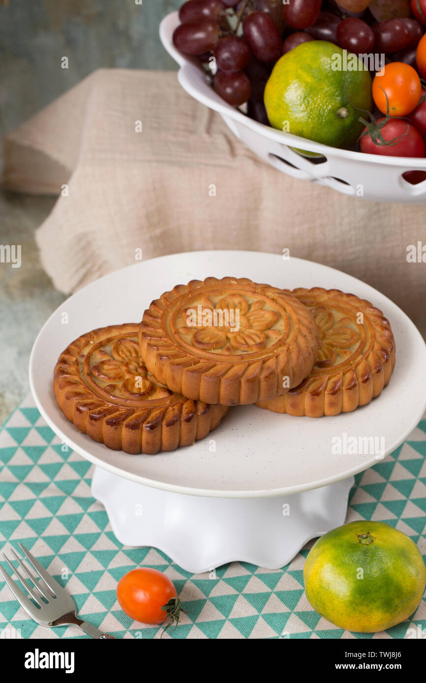Moon cakes and fruit on the table Stock Photo