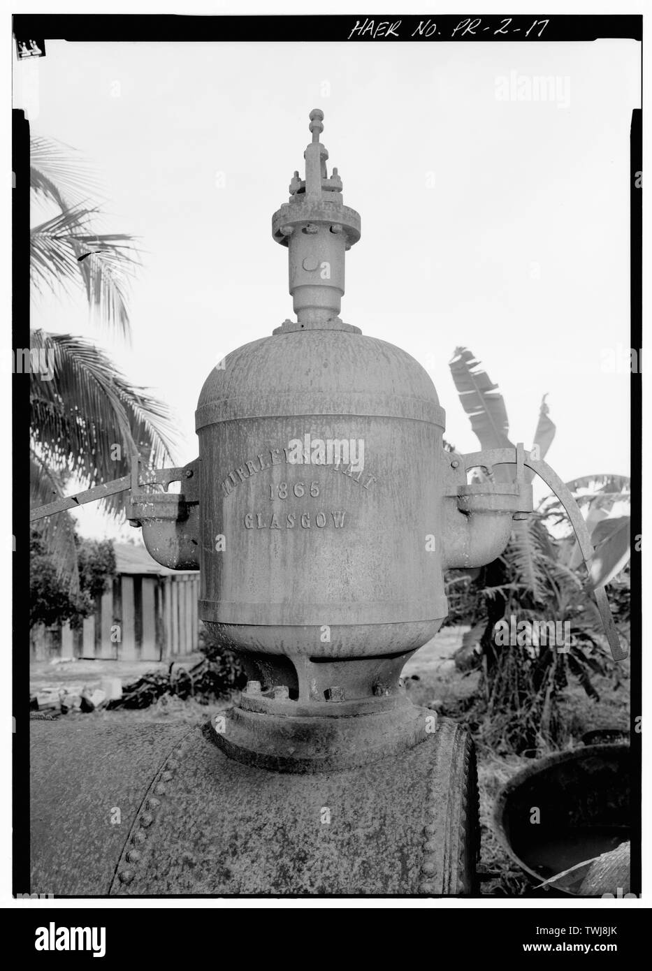 Side view of steam dome mounted on top of boiler; dome is marked 'Mirrlees and Tate, 1865, Glasgow.' - Hacienda Azucarera La Concepcion, Sugar Mill Ruins, .3 Mi. W. of Junction of Rts. 418 and 111, Victoria, Agaudilla Municipio, PR; Quinones, Dona Eulalia; Cardona, Jose Weston; Central Coloso; Mirrlees and Tait; Johnson, Robert L, field team; Griffin, Douglas L, project manager; DeLony, Eric N, project manager; Conservation Trust of Puerto Rico, sponsor; Freeman, Belmont, delineator; del Cueto, Beatriz, delineator; Yasuda, Beverly, delineator; Williams, Joan, historian; Boucher, Jack, photogra Stock Photo