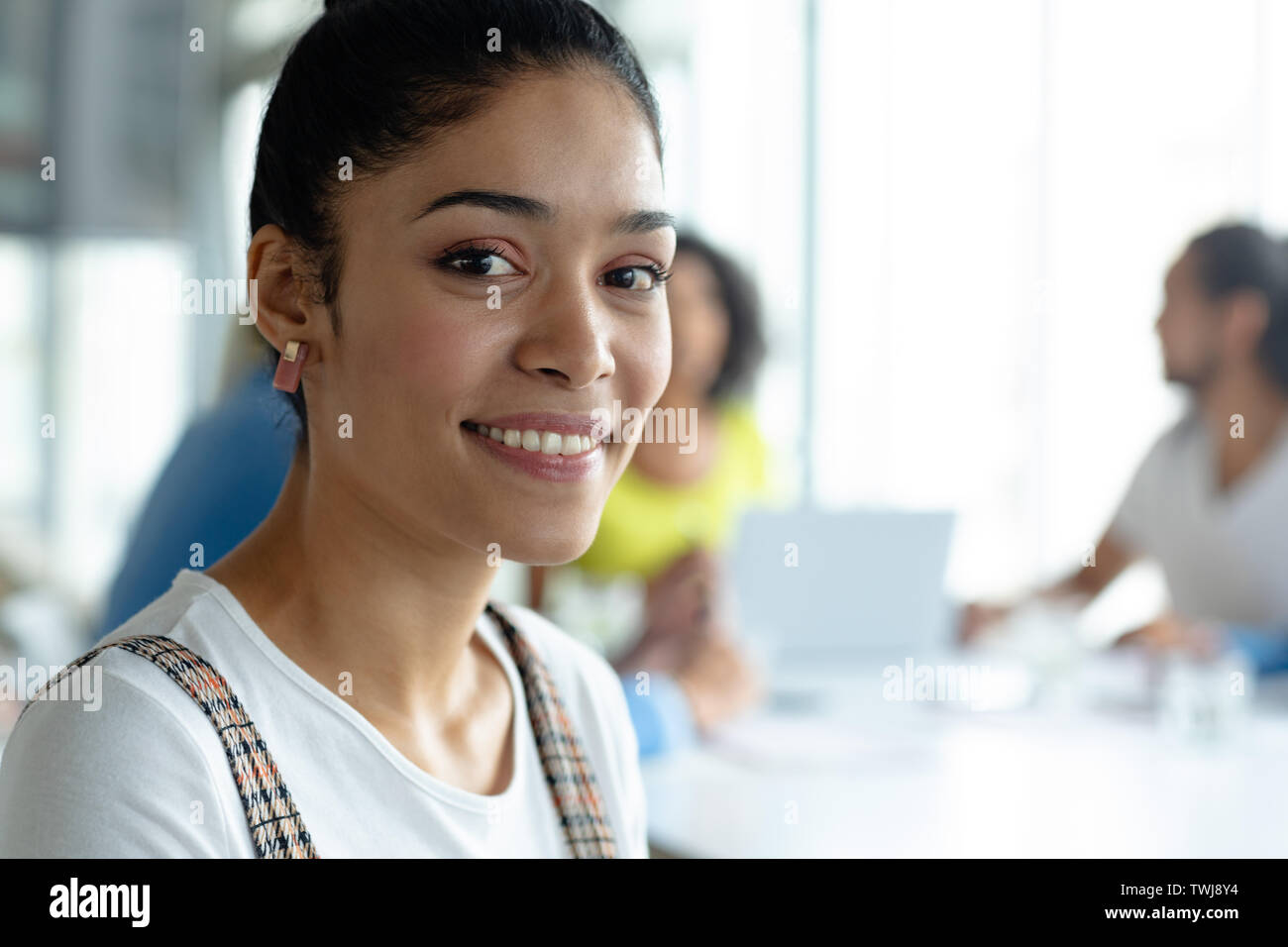 Happy businesswoman looking at camera in a modern office Stock Photo