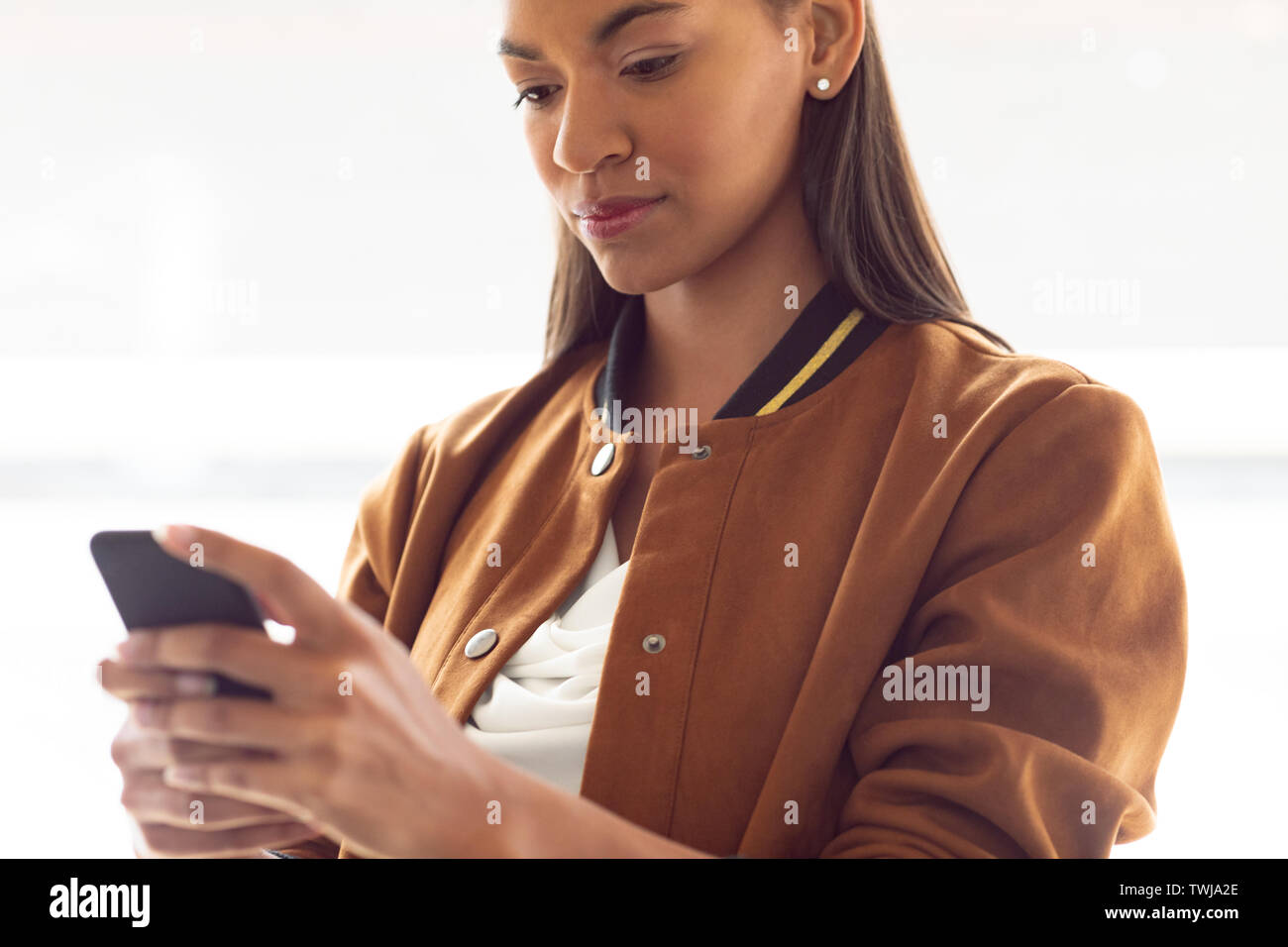 Businesswoman using mobile phone in a modern office Stock Photo
