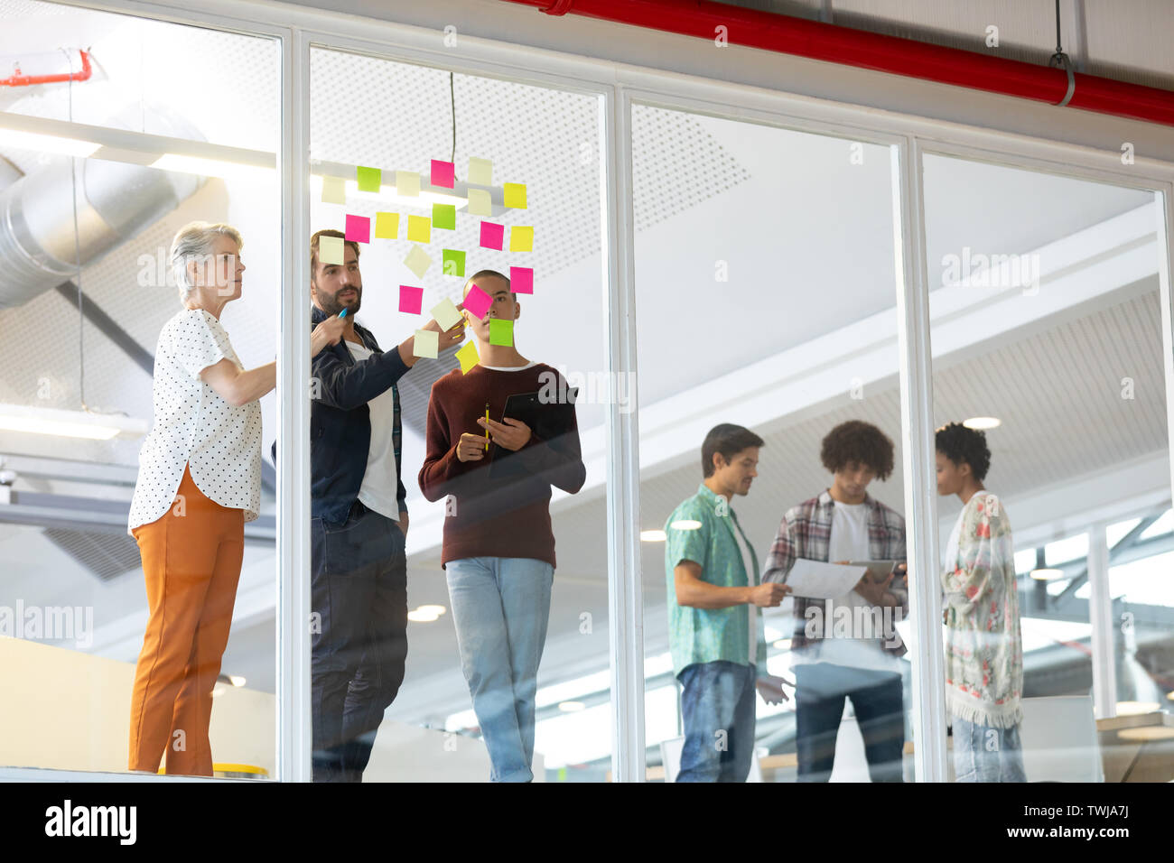 Business people discussing over sticky notes in the office Stock Photo ...