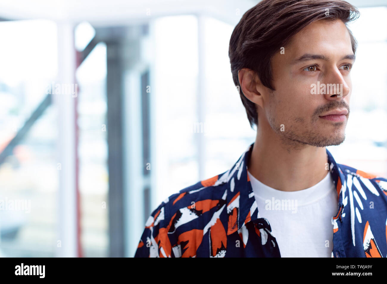 Male businessman looking away in a modern office Stock Photo