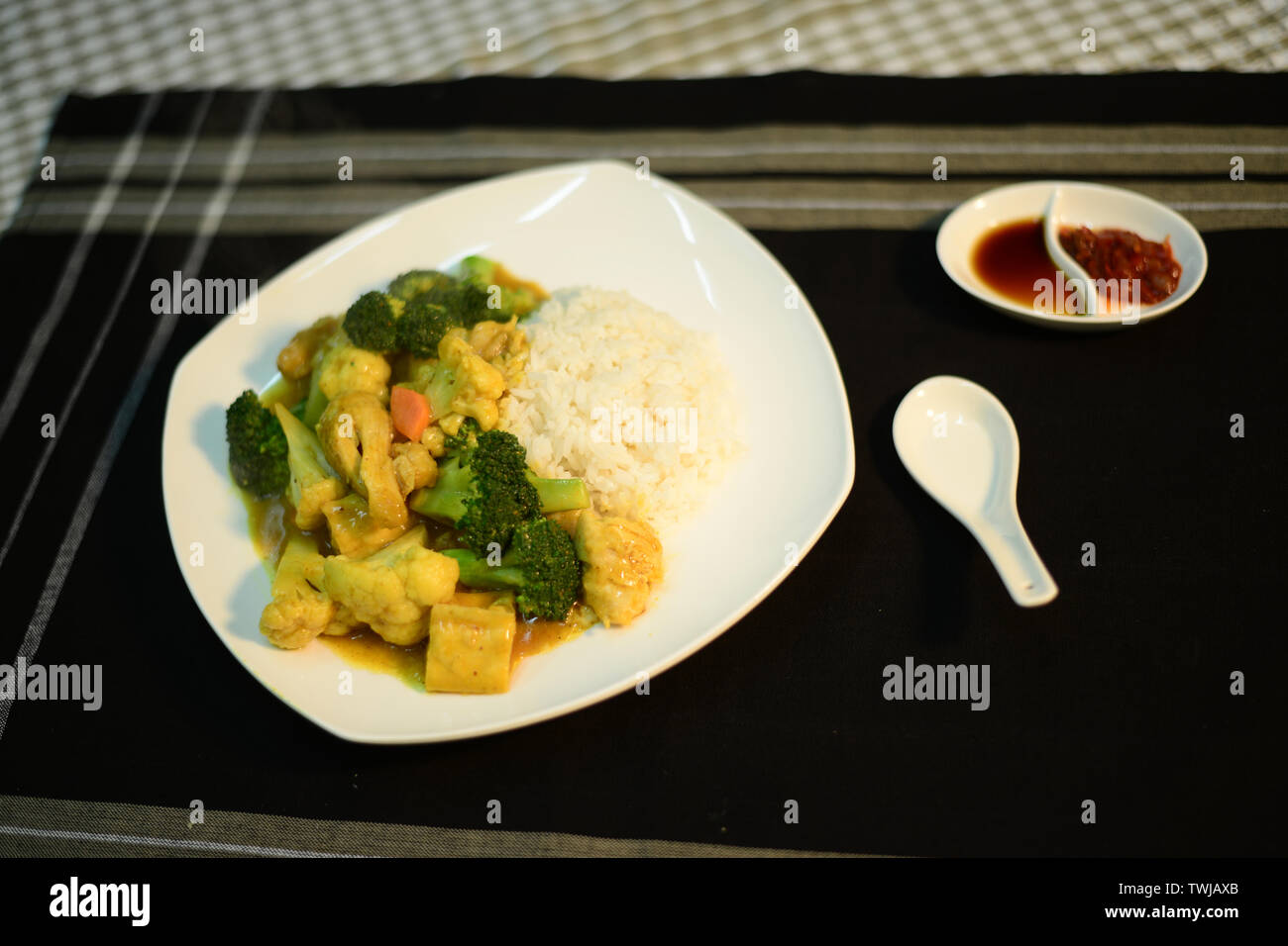 vegetarian curry on rice, setup nicely on a table ready to serve Stock Photo